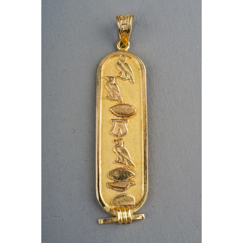 6 - An Egyptian yellow gold pendant, cast with hieroglyphics, control mark to back, approx 5.2cm long, g... 