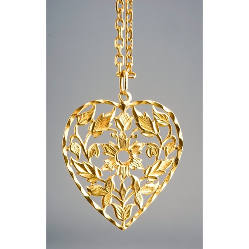 10 - A yellow gold pendant and chain, the chased and pierced heart shape pendant suspended from a square-... 