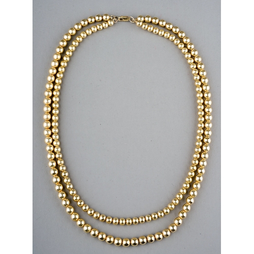 24 - A yellow gold double strand necklace, two rows of beads, the larger approx 7mm the smaller approx 6.... 