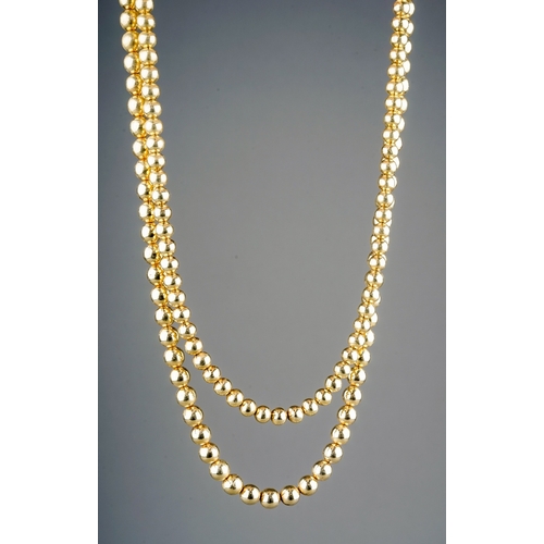 24 - A yellow gold double strand necklace, two rows of beads, the larger approx 7mm the smaller approx 6.... 