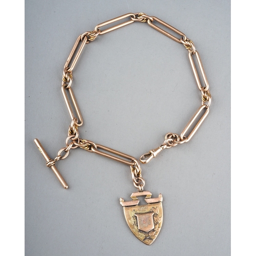 27 - A Victorian 9ct yellow gold trombone link watch chain, with shield fob and t-bar, chain approx 37.5c... 