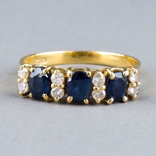 50 - An 18ct yellow gold sapphire and diamond ring, set with three oval-cut sapphires and eight round bri... 