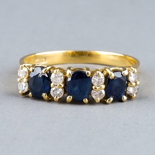 50 - An 18ct yellow gold sapphire and diamond ring, set with three oval-cut sapphires and eight round bri... 