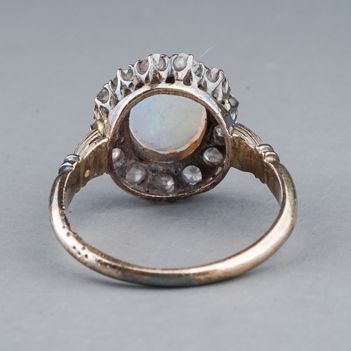 54 - An Edwardian opal and diamond dress ring, set with an oval cabochon precious opal approx 7mm x 8.6mm... 