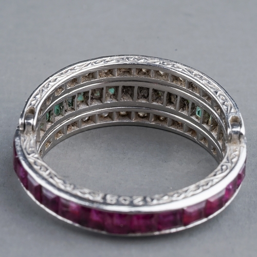 55 - An Art Deco platinum diamond ruby and emerald swivel or flip ring, set with calibre cut rubies and e... 