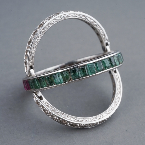 55 - An Art Deco platinum diamond ruby and emerald swivel or flip ring, set with calibre cut rubies and e... 