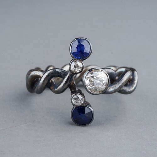 59 - A diamond and sapphire dress ring, set with three old-cut diamonds and two sapphires, on an intertwi... 