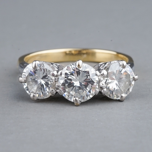 62 - A yellow gold and diamond three-stone ring, set with round brilliant-cut diamonds, centre stone appr... 