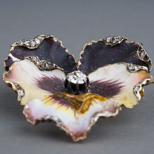 69 - A Victorian enamel and diamond pansy brooch, set with an old-cut diamond in polychrome enamel petals... 