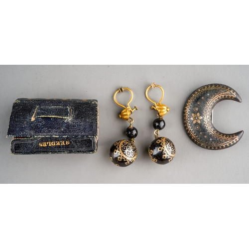 70 - A 19th Century tortoiseshell and gold pique brooch, the crescent shaped brooch set with scroll and f... 