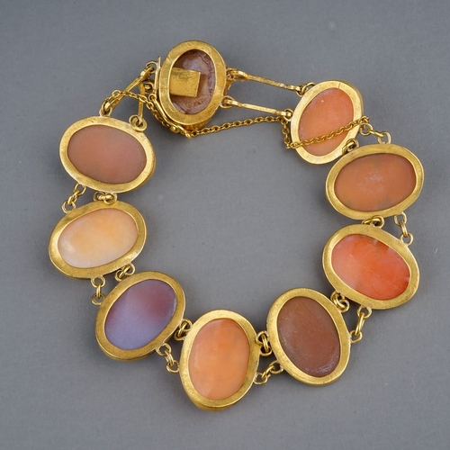 72 - A late 19th/early 20th century yellow gold cameo bracelet, set with nine oval cameos, link spacers, ... 