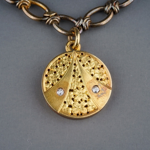 74 - A yellow gold bracelet and diamond locket, the fancy-link bracelet suspending a yellow circular lock... 