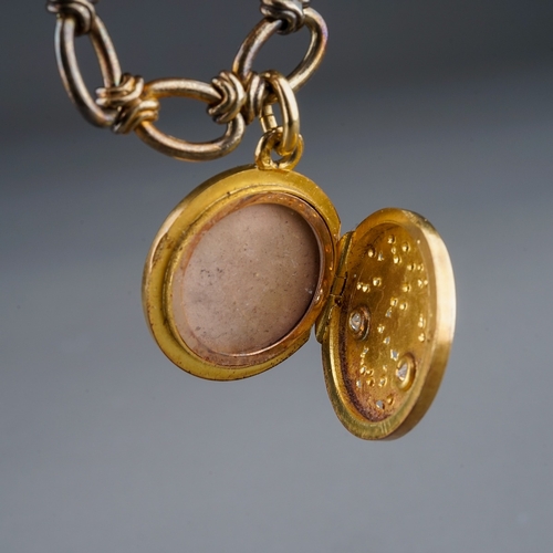 74 - A yellow gold bracelet and diamond locket, the fancy-link bracelet suspending a yellow circular lock... 