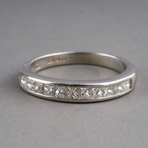 82 - A platinum and diamond half eternity ring, set with eleven princess-cut diamonds, size I1/2, gross w... 