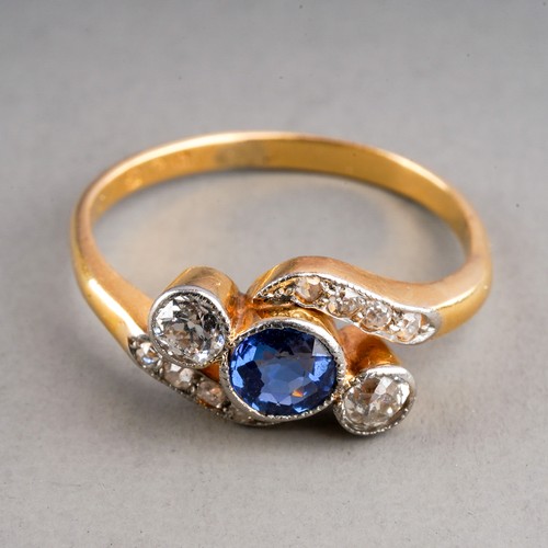 84 - An early 20th century sapphire and diamond ring, set with a sapphire flanked by two old-cut diamonds... 