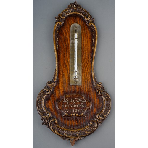 97 - A 20th Century Gilbey's Spey-Royal Whiskey wall thermometer, with carved borders, approx 34cm long