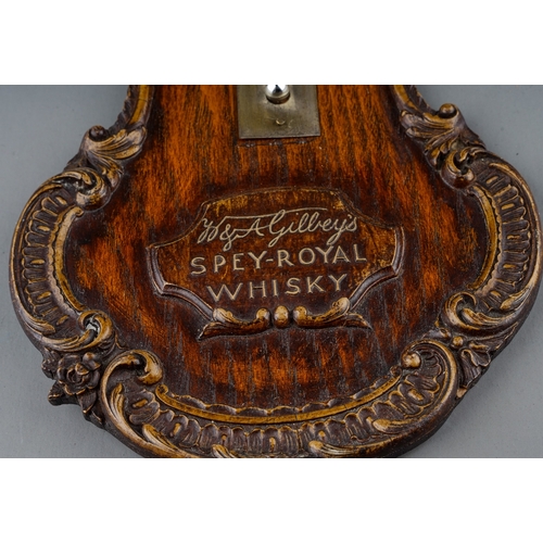 97 - A 20th Century Gilbey's Spey-Royal Whiskey wall thermometer, with carved borders, approx 34cm long