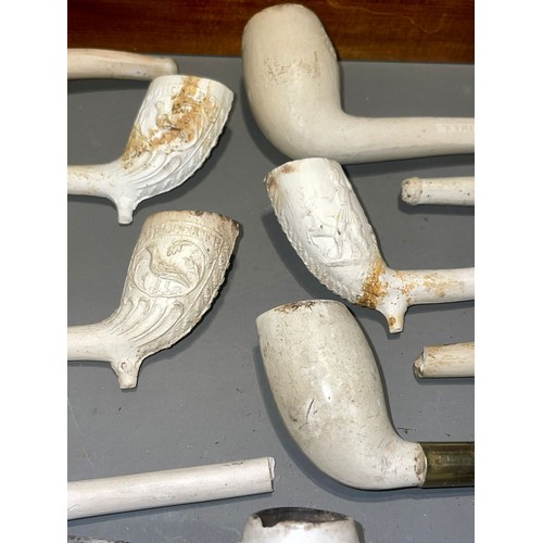 118 - A collection of clay pipes with a money box and stand (1 box)