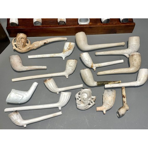 118 - A collection of clay pipes with a money box and stand (1 box)