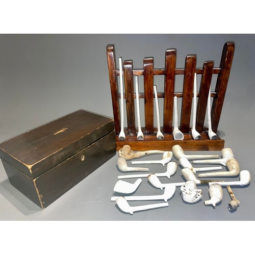 118 - A collection of clay pipes with a money box and stand (1 box)