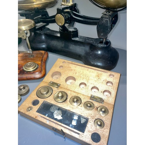 123 - Three early 20th Century brass mounted weighing scales with various weights (a/f)