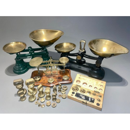 123 - Three early 20th Century brass mounted weighing scales with various weights (a/f)