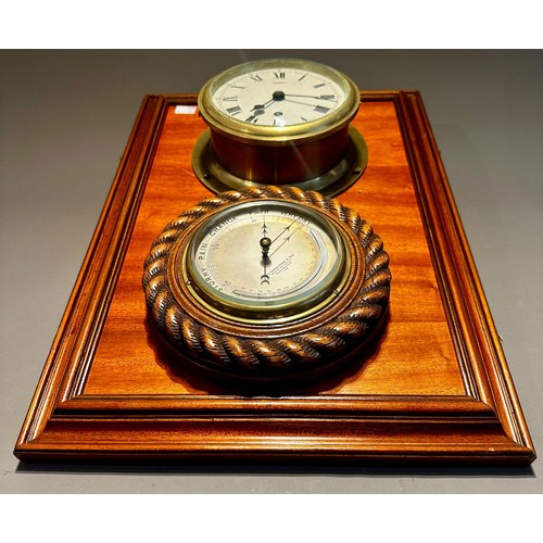 130 - A mounted brass Ship's clock and wooden mounted barometer together with a Modern brass and green gla... 