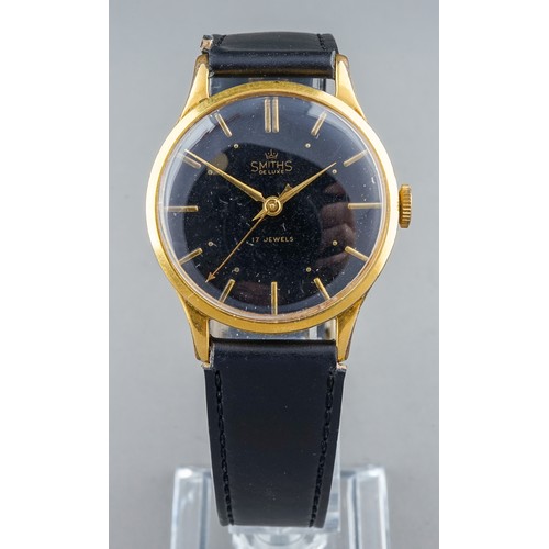 171 - A gentleman's Smiths De Luxe gold plated wristwatch, 29mm circular black dial with baton indicators,... 