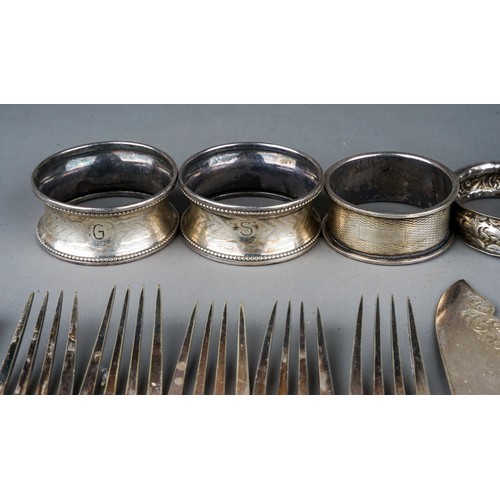 180 - A collection of seven various 20th Century silver napkin rings and spoons, various dates and makers,... 