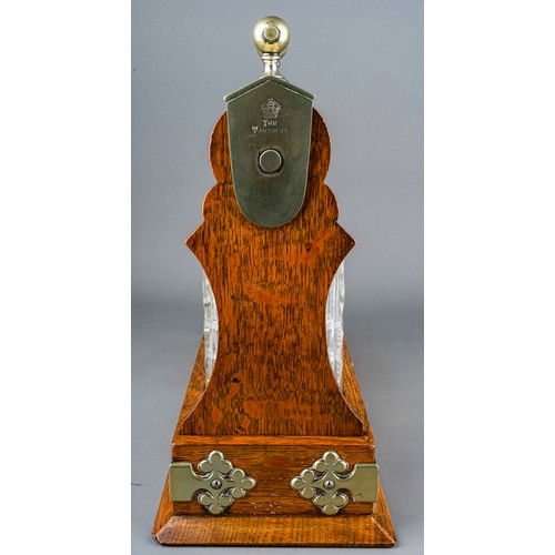 186 - An early 20th Century EPNS mounted oak tantalus fitted with three cut glass spirit decanter with sto... 