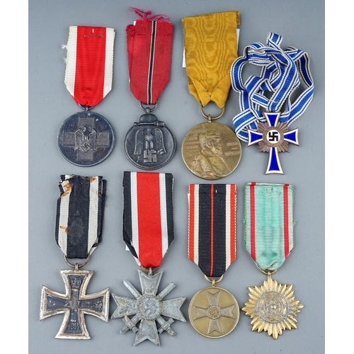 242 - A collection of 8 German Medals.  Eastern Front Medal, Mothers Cross in Bronze, War Merit Medal, Soc... 