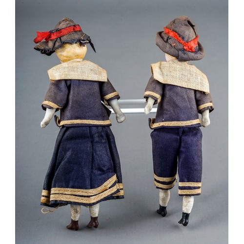 262 - A pair of early 20th Century small dolls dressed as a Sailor Boy and Girl, both with porcelain heads... 