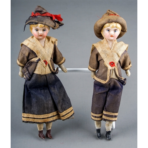 262 - A pair of early 20th Century small dolls dressed as a Sailor Boy and Girl, both with porcelain heads... 