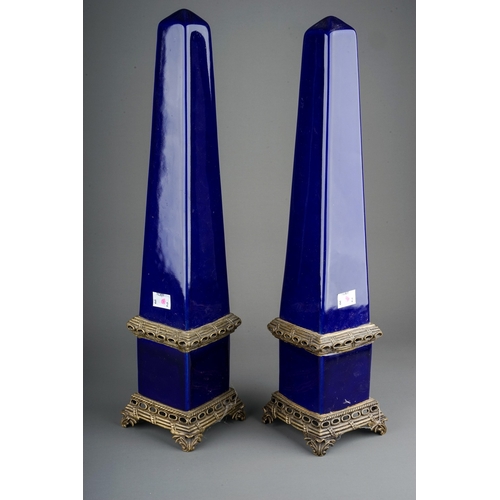 333 - A pair of 20th Century cobalt blue porcelain and gilt metal mounted decorative Obelisks on raised pi... 