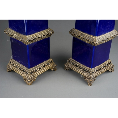 333 - A pair of 20th Century cobalt blue porcelain and gilt metal mounted decorative Obelisks on raised pi... 