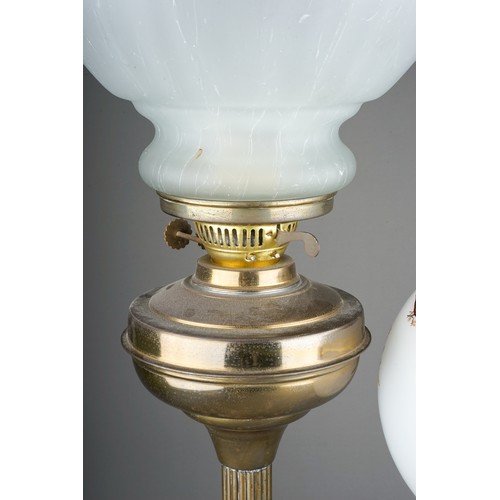 337 - Two early 20th Century oil lamps, one Duplex, the other  with column stem and globular shade painted... 