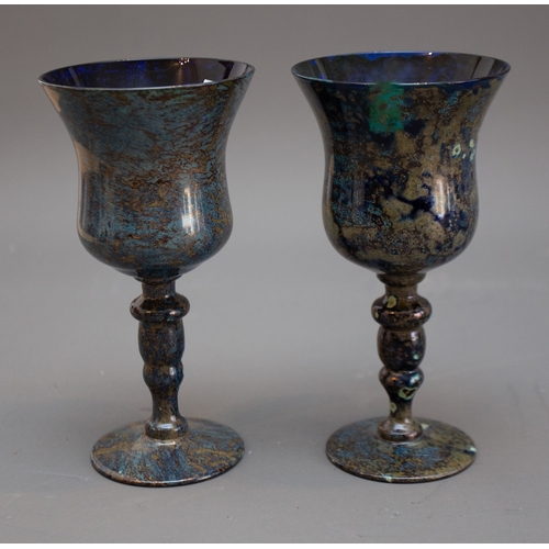 340 - A pair of 20th Century Continental blue glass wine goblets with marbled decorative overlay possibly ... 