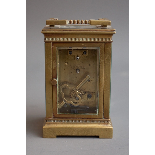 343 - An early 20th Century gilt metal mounted carriage clock, white enamel dial with Roman numerals, carr... 