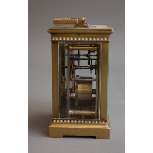 343 - An early 20th Century gilt metal mounted carriage clock, white enamel dial with Roman numerals, carr... 