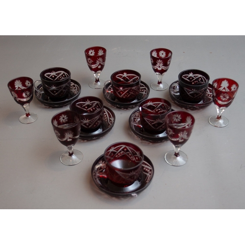 354 - A set of six Bohemian ruby glass teacups and saucers together with a set of six ruby flash glass por... 