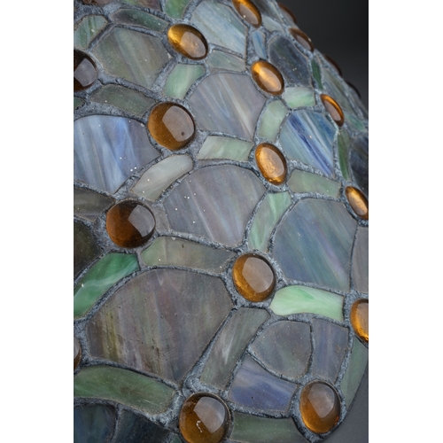 369 - A Continental Tiffany style stained glass lamp stylised fan decoration to shade and stand with amber... 