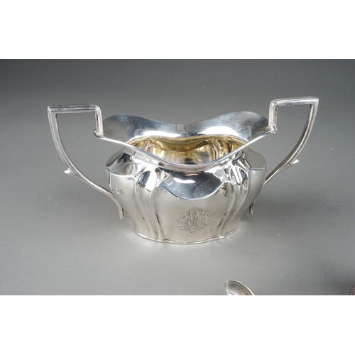 382 - A group of silver to include: Edwardian monogrammed milk jug and sugar bowl, by Robert Pringle, Lond... 