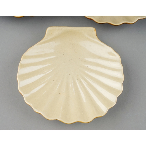 387 - Two Retro Poole pottery models of conch shells together with earthenware scallop dishes