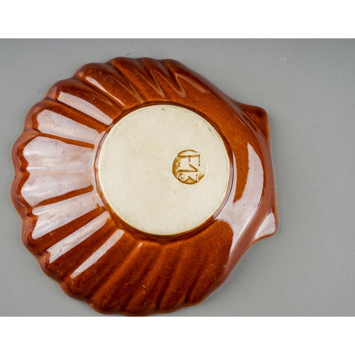 387 - Two Retro Poole pottery models of conch shells together with earthenware scallop dishes