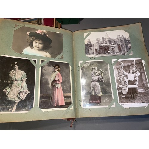 398 - Three early 20th Century postcard albums; Edwardian, War Time and later, one containing coloured or ... 