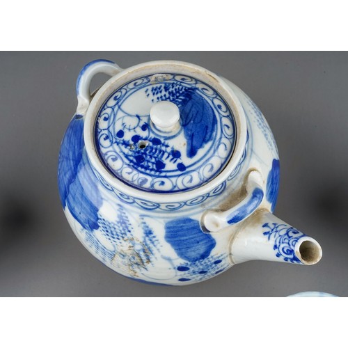 493 - An Asian probably Japanese blue and white tea pot and cover, decorated with foliage and flowers toge... 