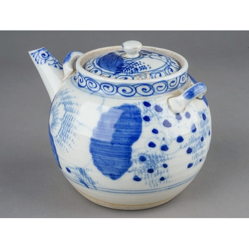 493 - An Asian probably Japanese blue and white tea pot and cover, decorated with foliage and flowers toge... 