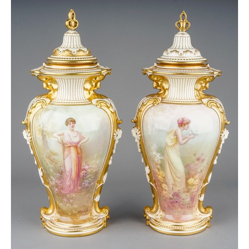 Arthur Leslie: a pair of early 20th Century Royal Doulton vases and covers, urn shaped bodies applied with acanthus leaf strapwork to each sides terminating with Fawns' head to collar, gilt heightened, one painted with a Classical maiden holding a dove, the other with Maiden leaning against a plinth, both with flowers to reverse, both signed by Arthur Leslie, both covers with pierced trefid finials and raised gilt jewel decoration, green factory stamp, impressed 1239, painted RA 7336 D., approx 31cm high