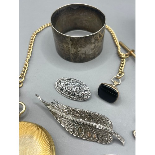 589 - A sterling silver and marcasite feather brooch; another silver and marcasite brooch; silver brooch; ... 