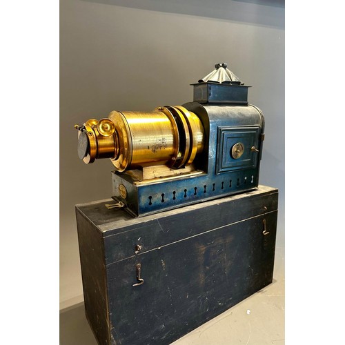 414 - A late 19th Century tin plate and brass magic lantern with Stocks patent lamp, in tinplate carrying ... 